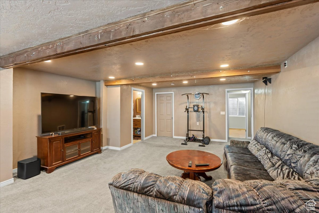 Carpeted living area with baseboards and recessed lighting