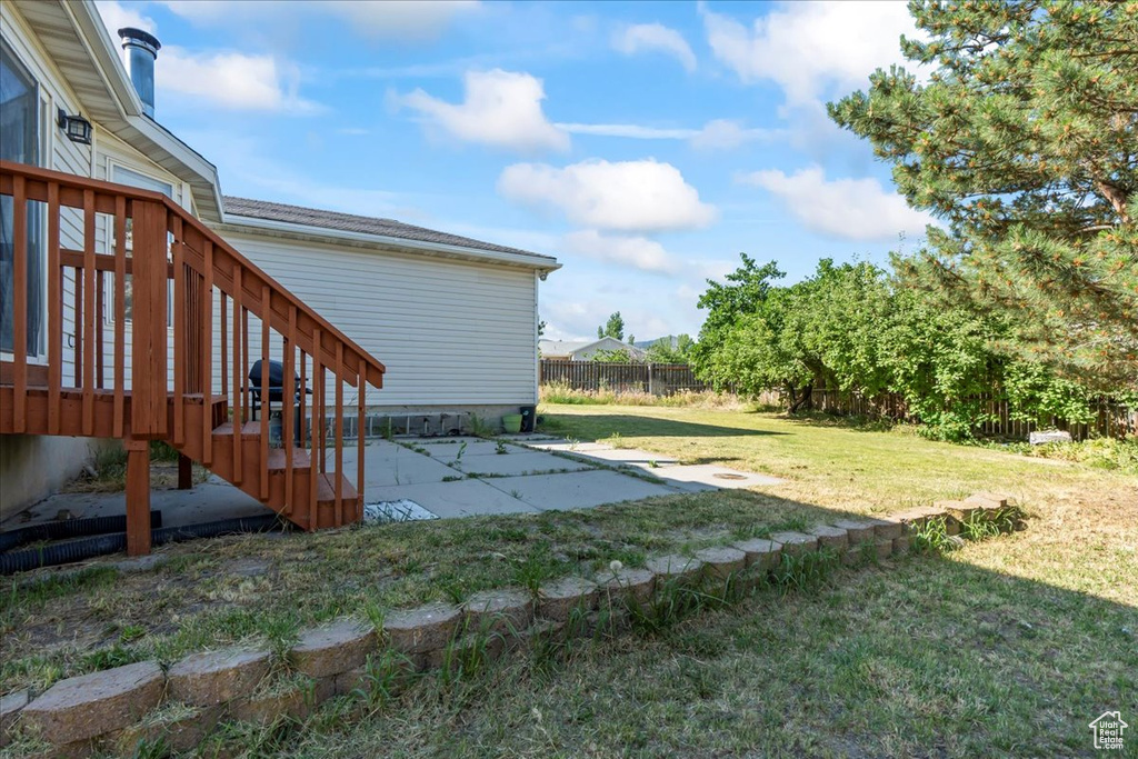View of yard with a patio and a deck