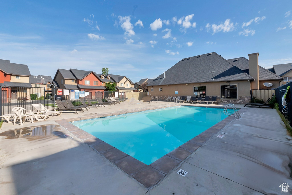 Community pool with a residential view and a patio area