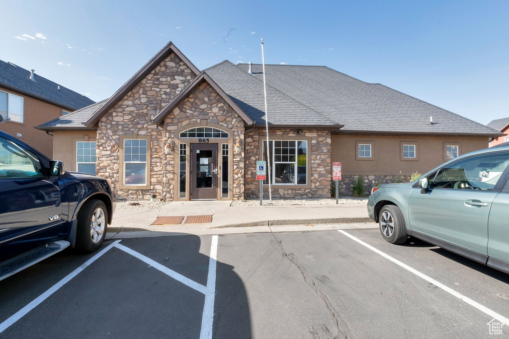View of building exterior featuring uncovered parking