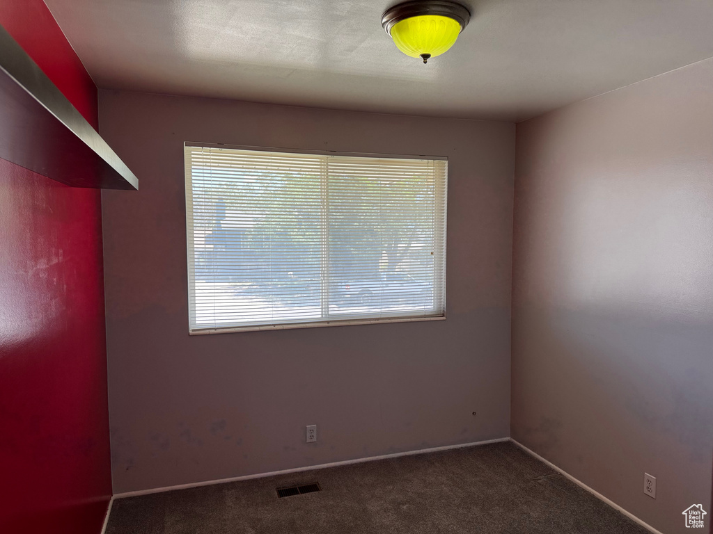 Unfurnished room with carpet flooring and baseboards