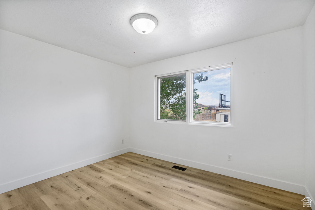 Spare room featuring light wood-type flooring