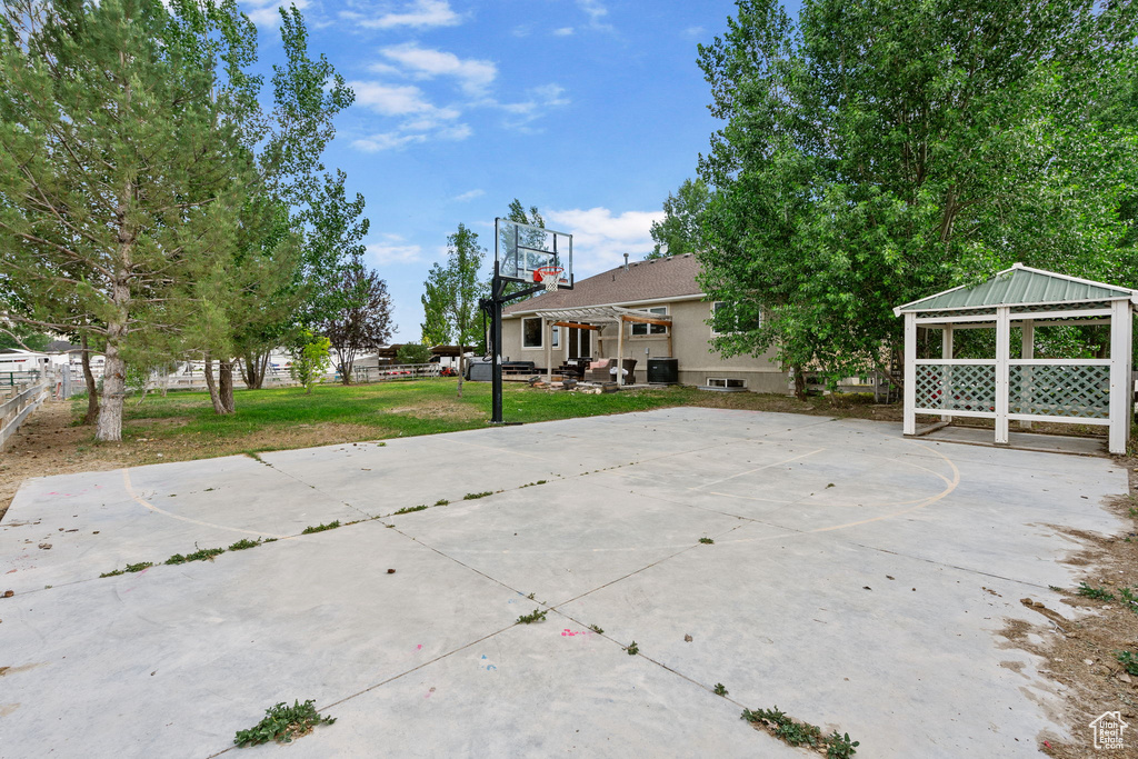 View of patio featuring basketball hoop and a gazebo