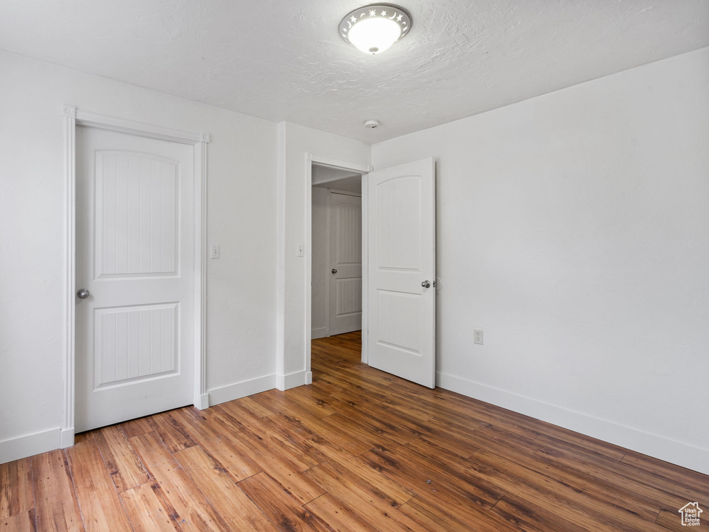 Unfurnished bedroom featuring wood finished floors