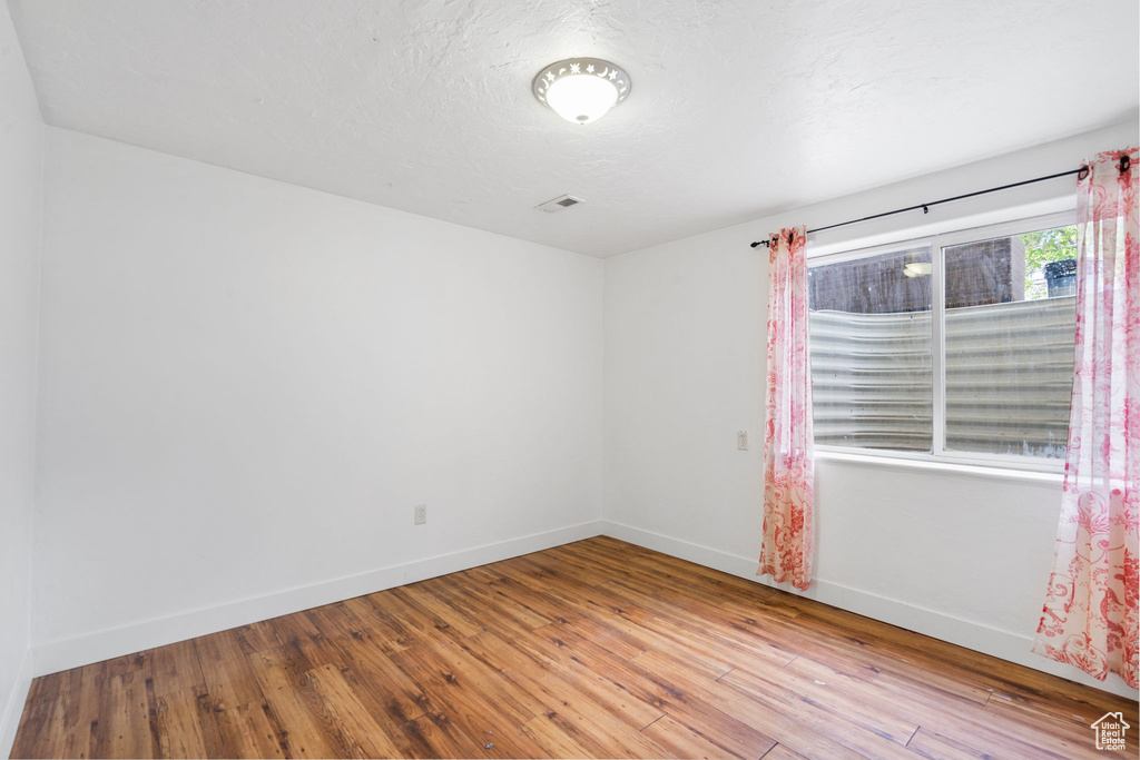 Empty room featuring hardwood / wood-style flooring