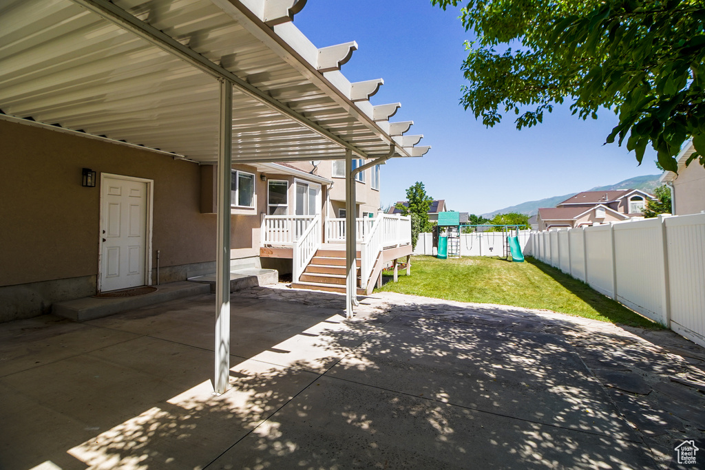 View of patio / terrace with a playground and a wooden deck