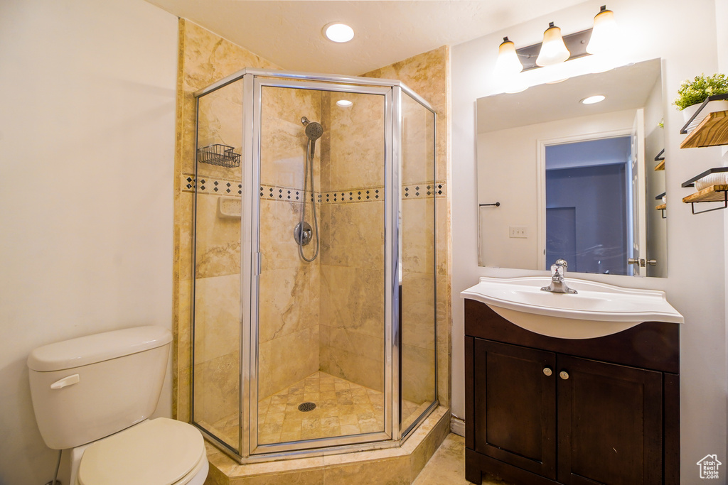 Bathroom featuring vanity, a shower stall, and recessed lighting
