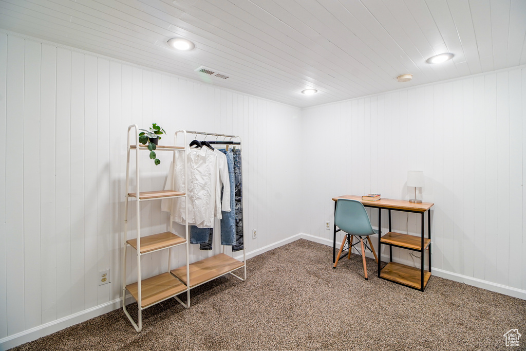 Misc room with carpet flooring, wood ceiling, and a desk