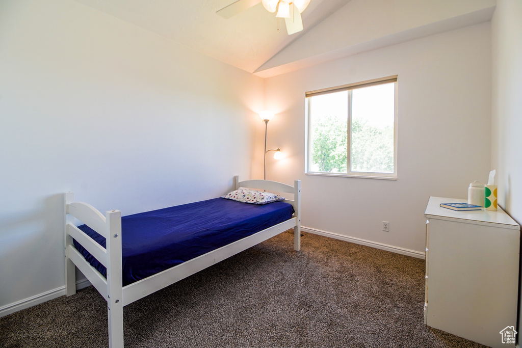 Bedroom featuring lofted ceiling, carpet flooring, and a ceiling fan
