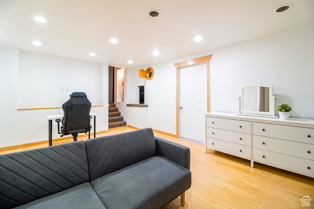 Living room with recessed lighting, stairs, and light wood-style flooring