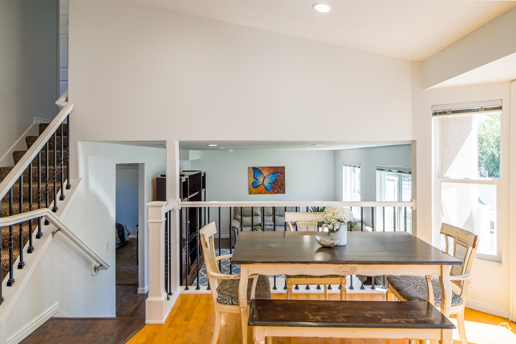 Dining room with wood finished floors and recessed lighting