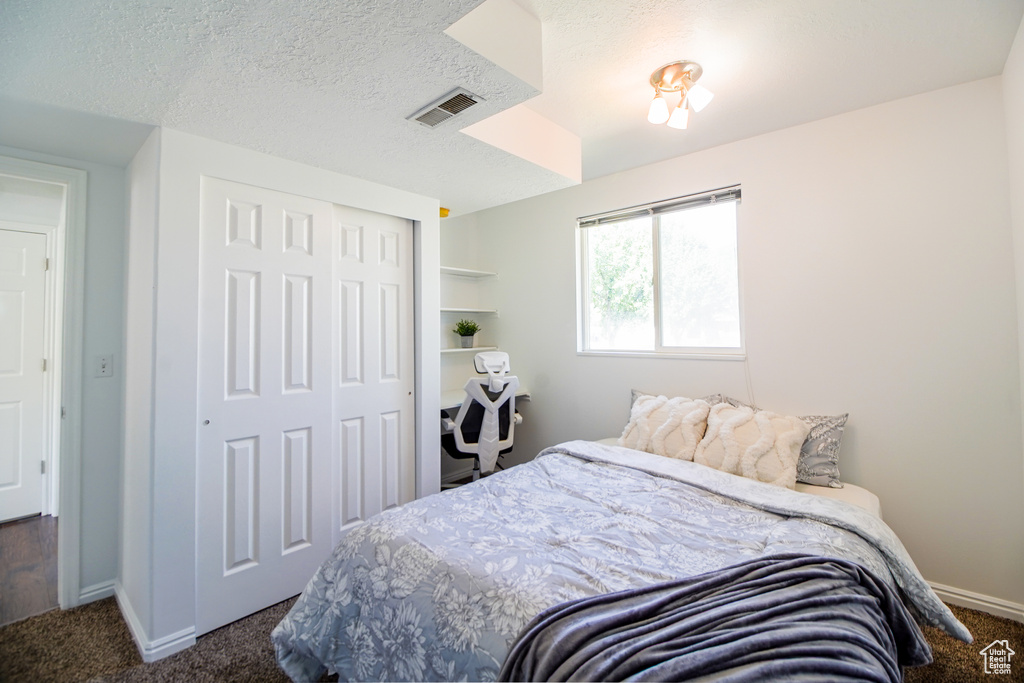 Bedroom featuring carpet floors and a closet