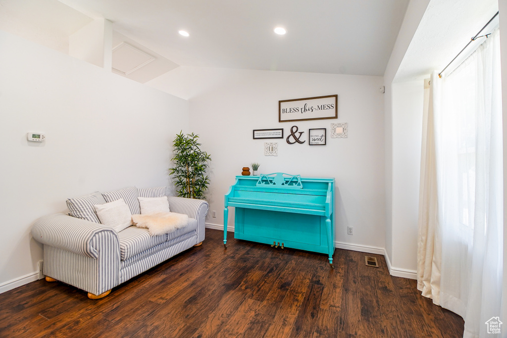 Living area featuring vaulted ceiling, wood finished floors, and recessed lighting