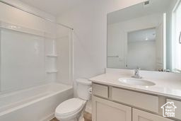 Bathroom with vanity and shower / tub combination