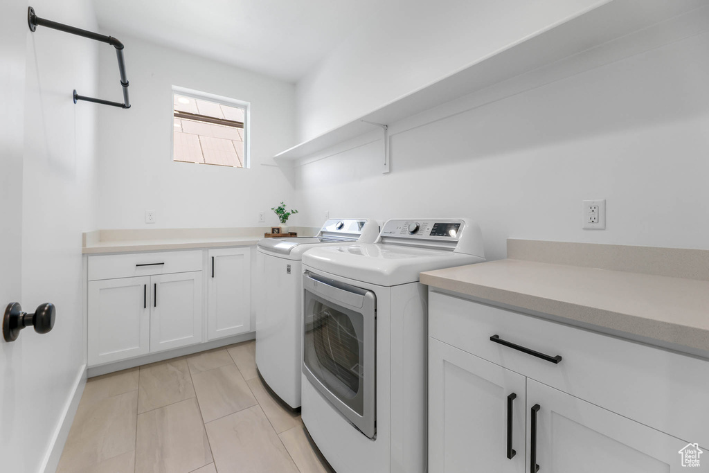 Washroom with washer and dryer and cabinet space