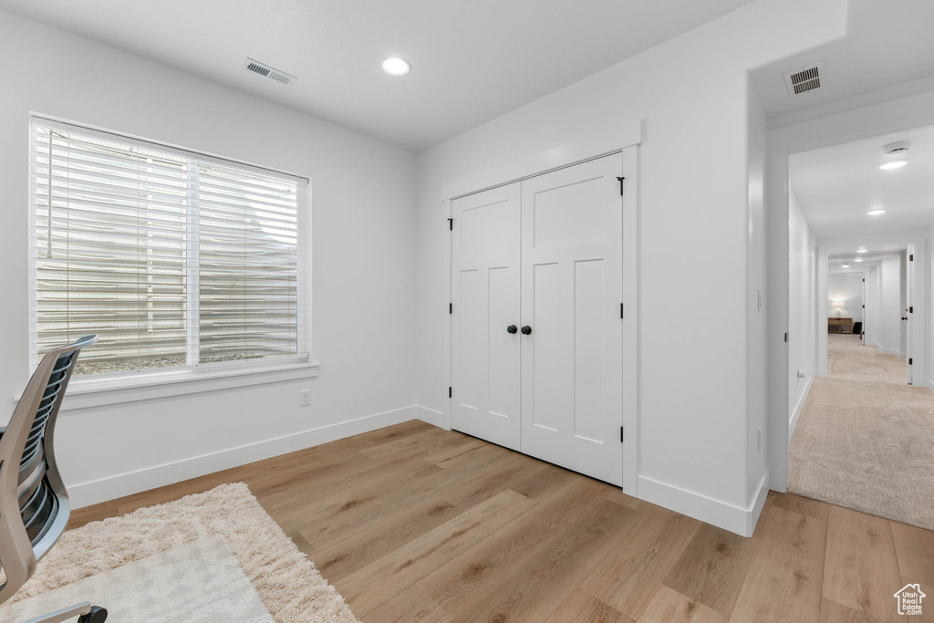 Unfurnished office featuring healthy amount of natural light, light wood-style flooring, and recessed lighting
