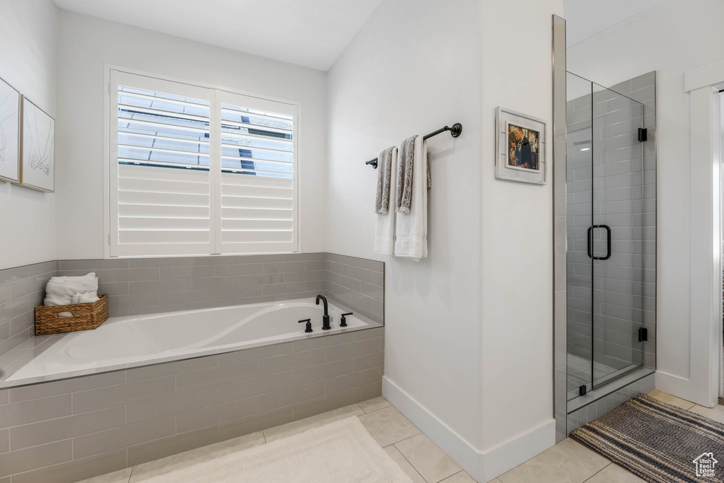 Bathroom with a bath, a stall shower, and tile patterned flooring
