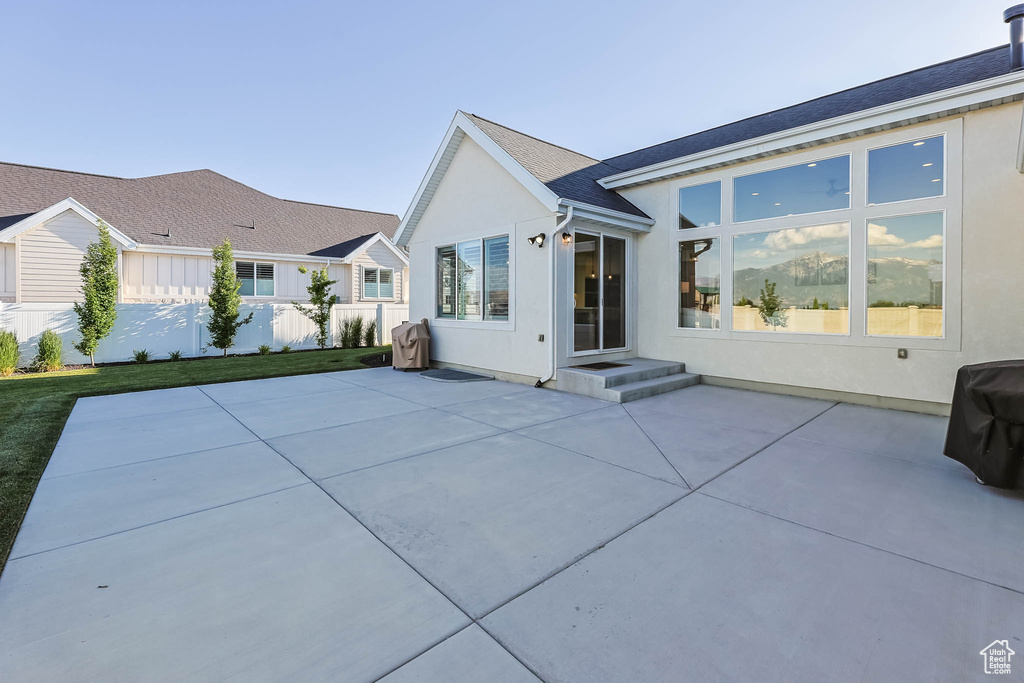 Rear view of property with stucco siding and a patio