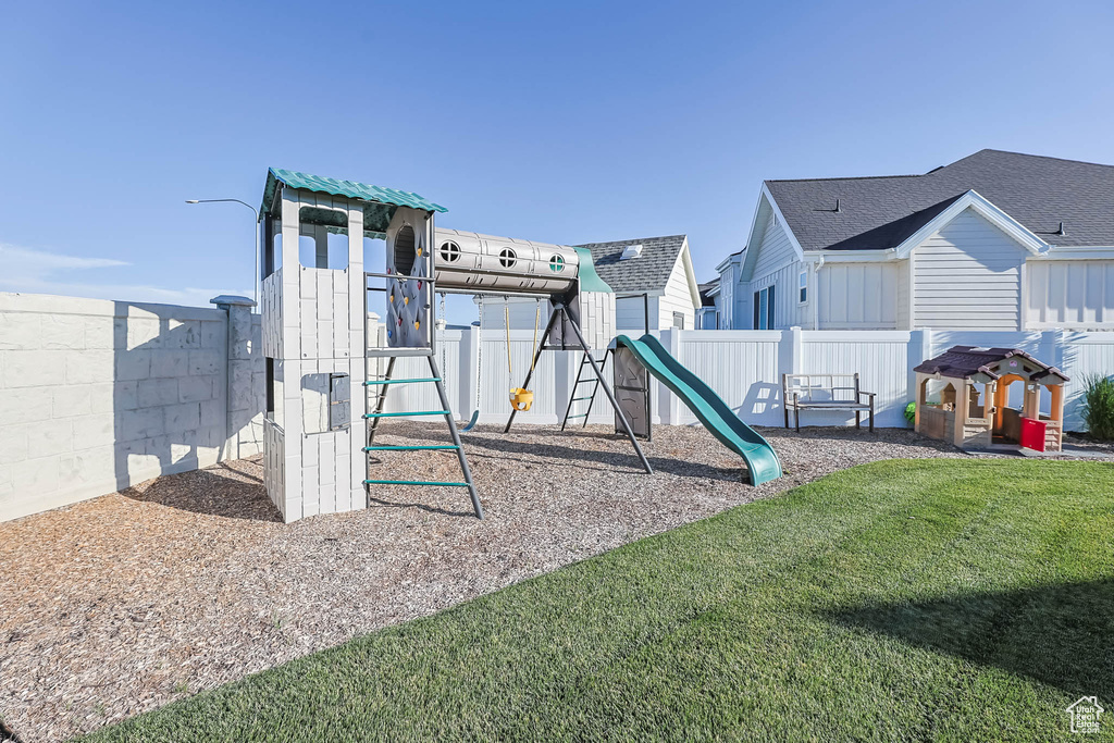 Communal playground featuring a fenced backyard