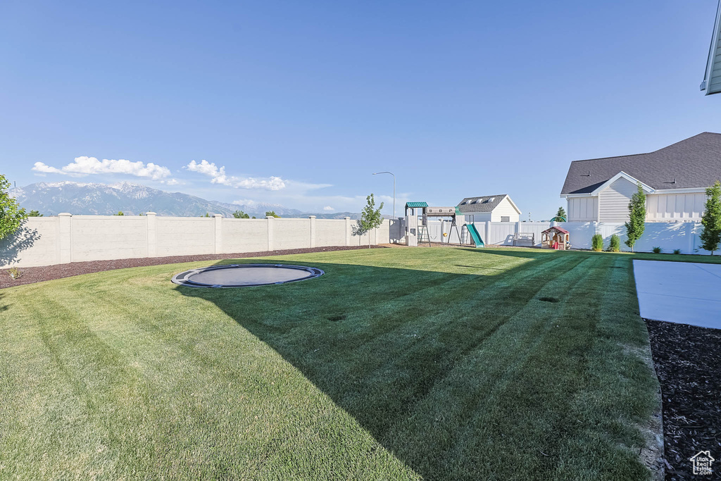 Fenced backyard with a playground