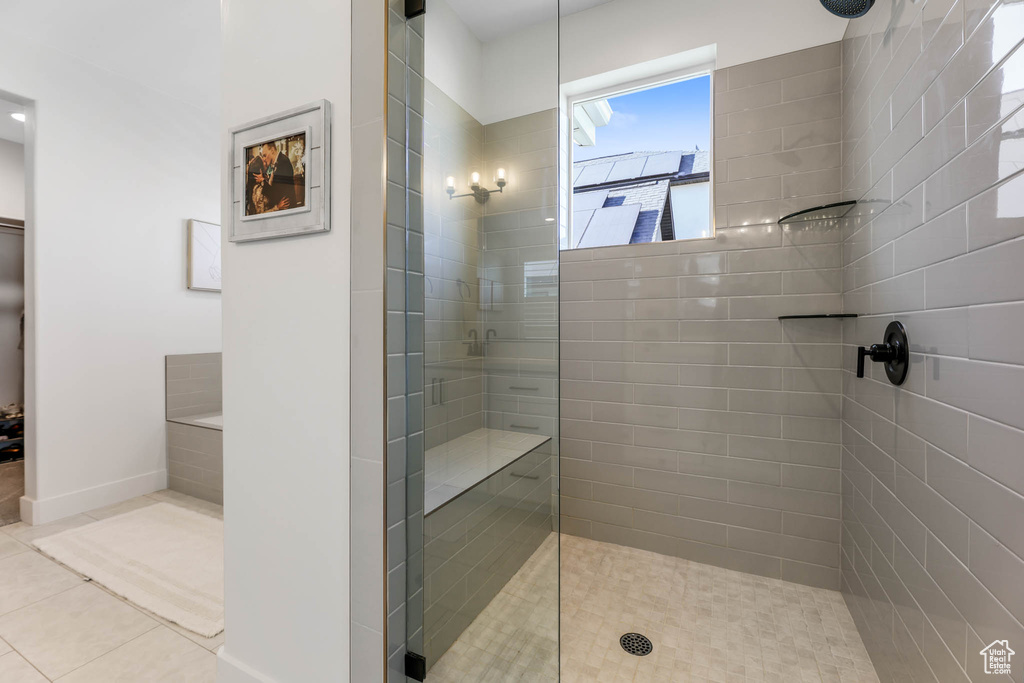Bathroom with a tile shower and tile patterned floors