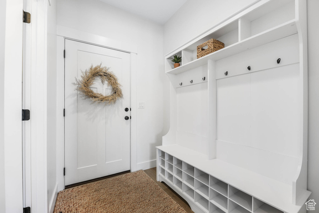 Mudroom featuring wood finished floors and baseboards