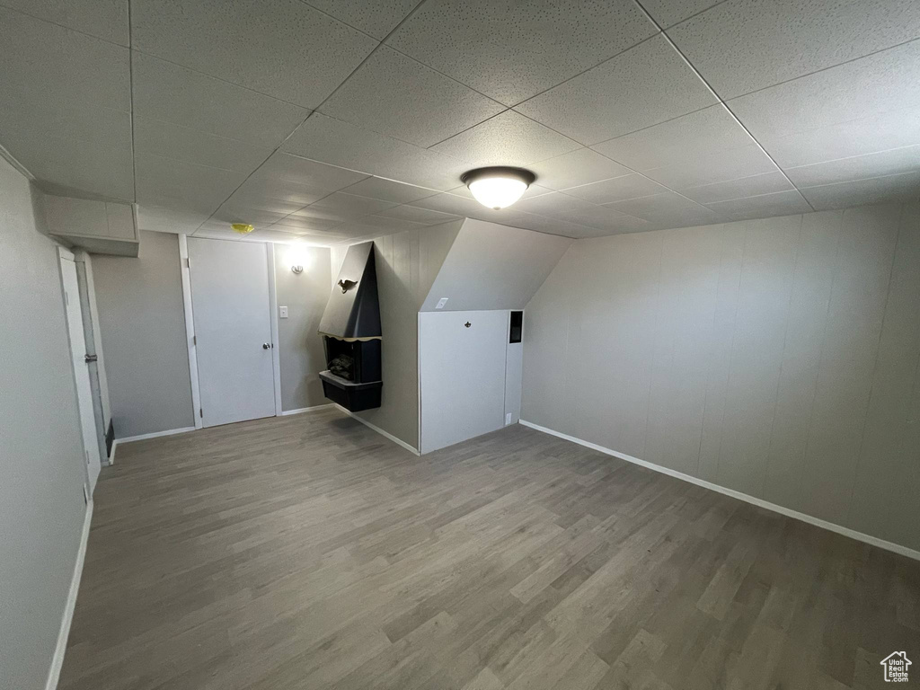 Bonus room featuring wood finished floors and baseboards