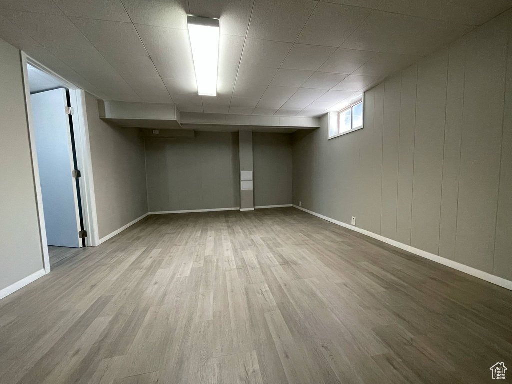 Basement featuring wood finished floors and baseboards