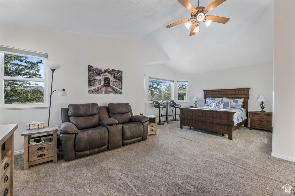 Bedroom with vaulted ceiling, carpet floors, and a ceiling fan