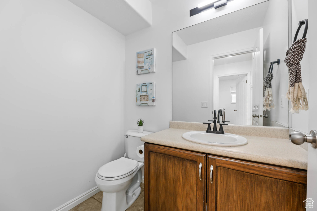Half bathroom featuring vanity and tile patterned floors