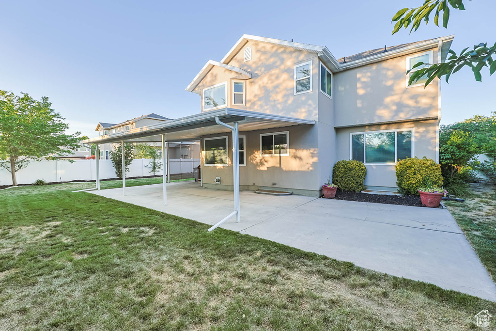 Rear view of property featuring a patio area and stucco siding