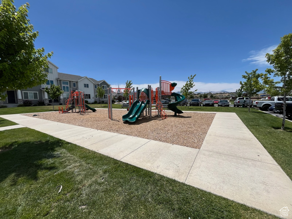 Communal playground with a lawn and a residential view