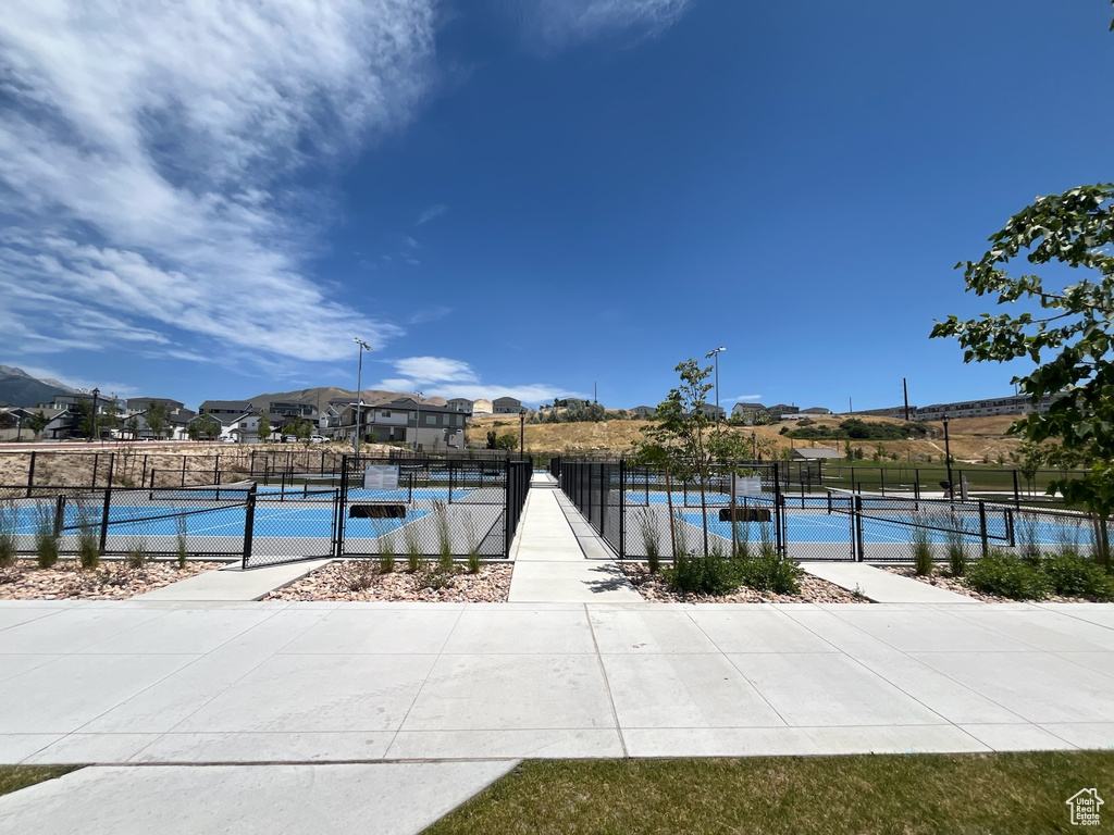 View of home's community with a tennis court and a residential view