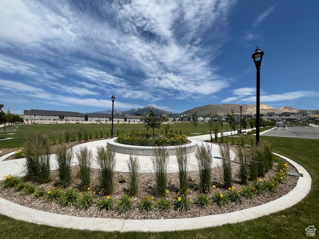 View of property's community featuring a mountain view and a yard