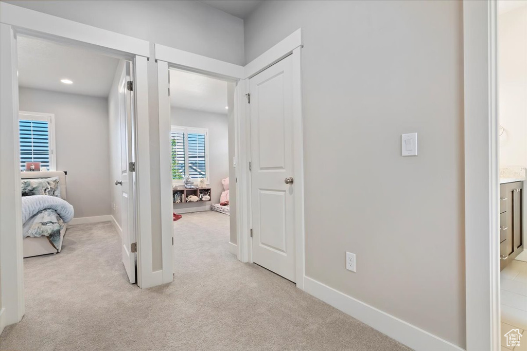 Hall featuring light colored carpet and recessed lighting