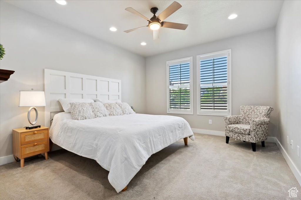 Bedroom with light colored carpet, recessed lighting, and a ceiling fan