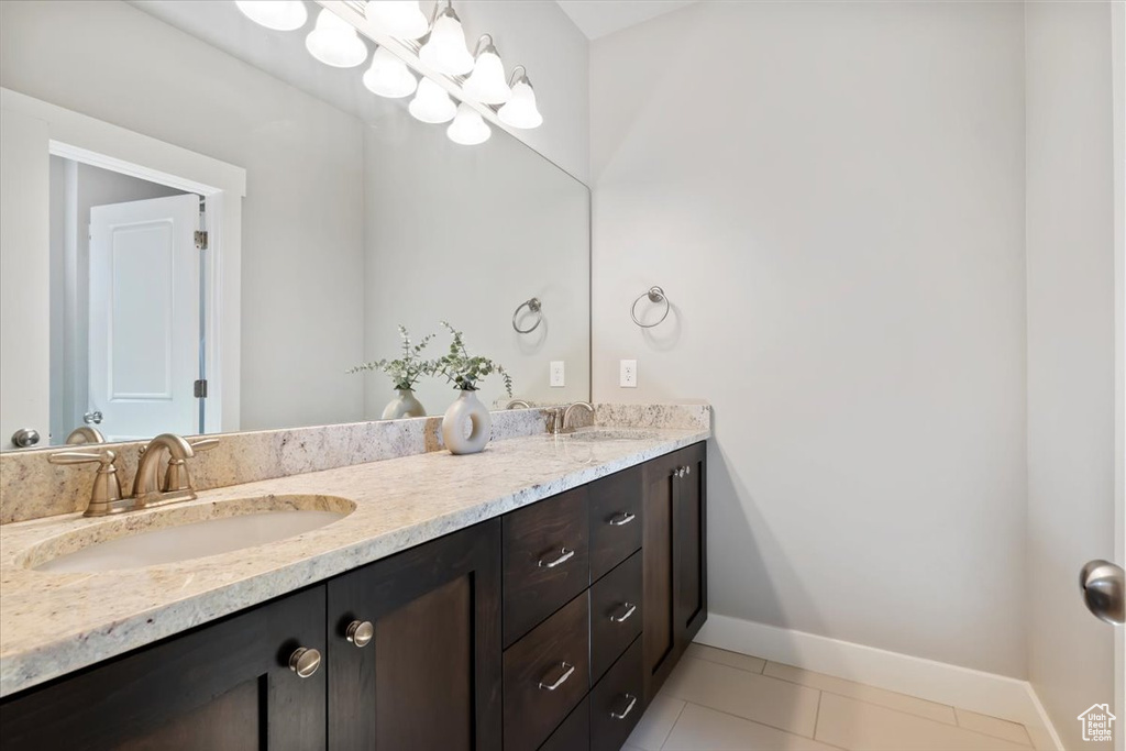 Bathroom featuring double vanity and tile patterned floors
