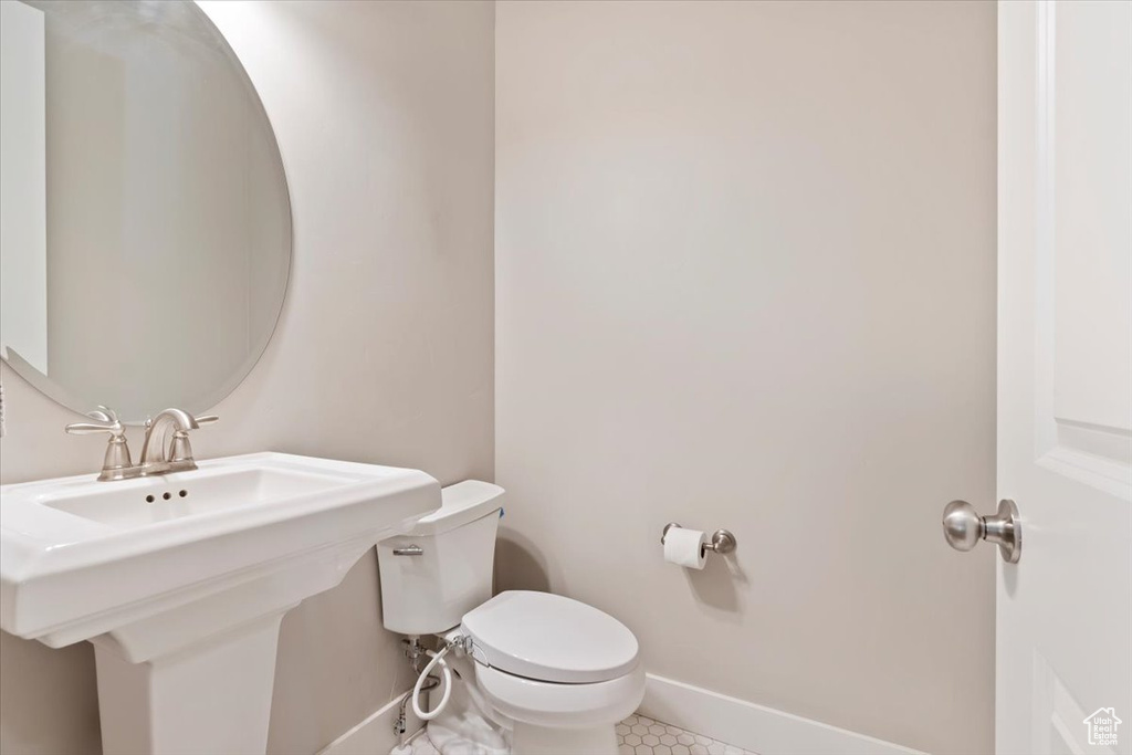 Bathroom featuring toilet and tile patterned floors