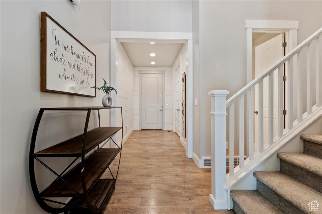 Foyer entrance featuring wood finished floors, stairway, and recessed lighting