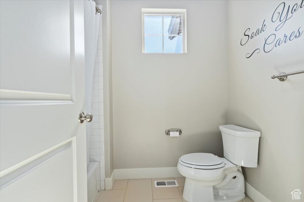 Bathroom with toilet and tile patterned floors