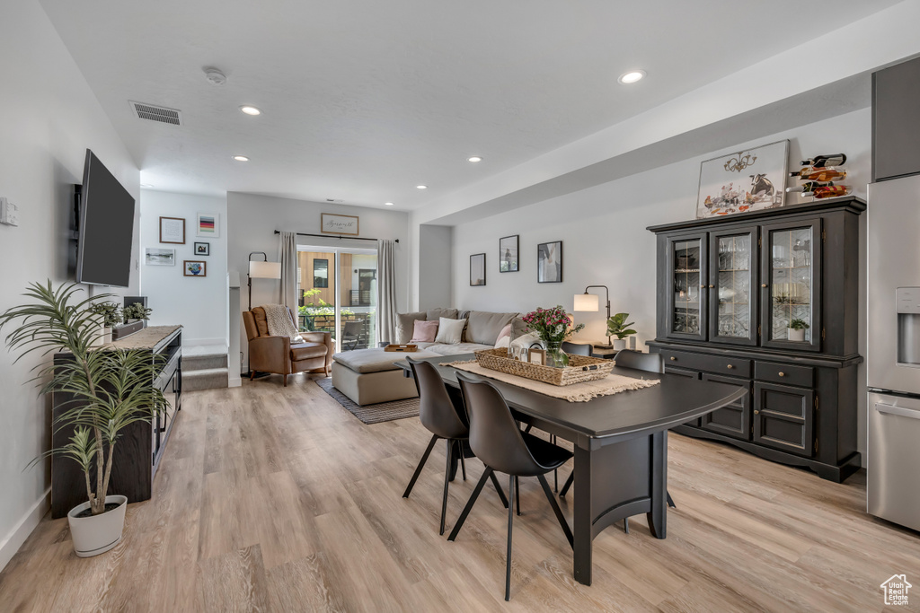 Dining space featuring light wood-style flooring and recessed lighting