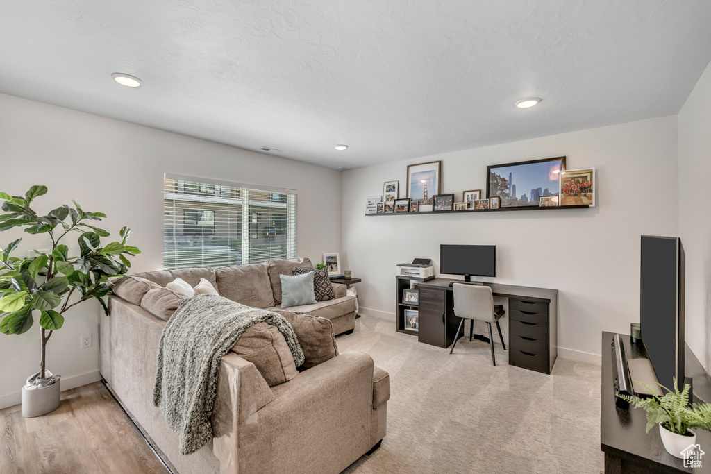 Living room featuring an office area and recessed lighting