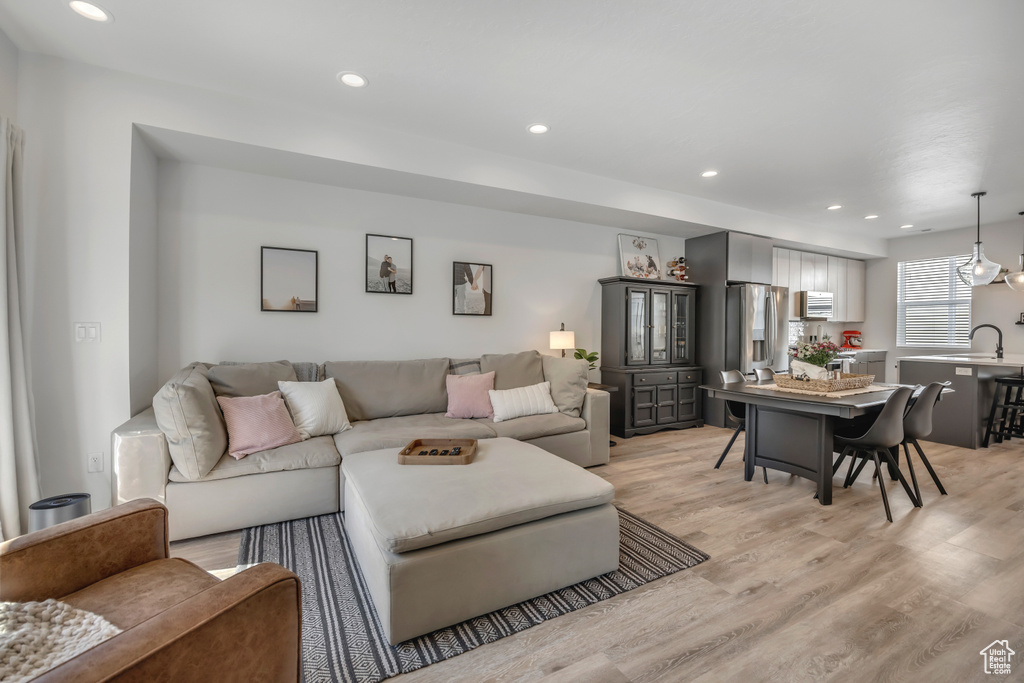 Living area featuring recessed lighting and light wood-type flooring