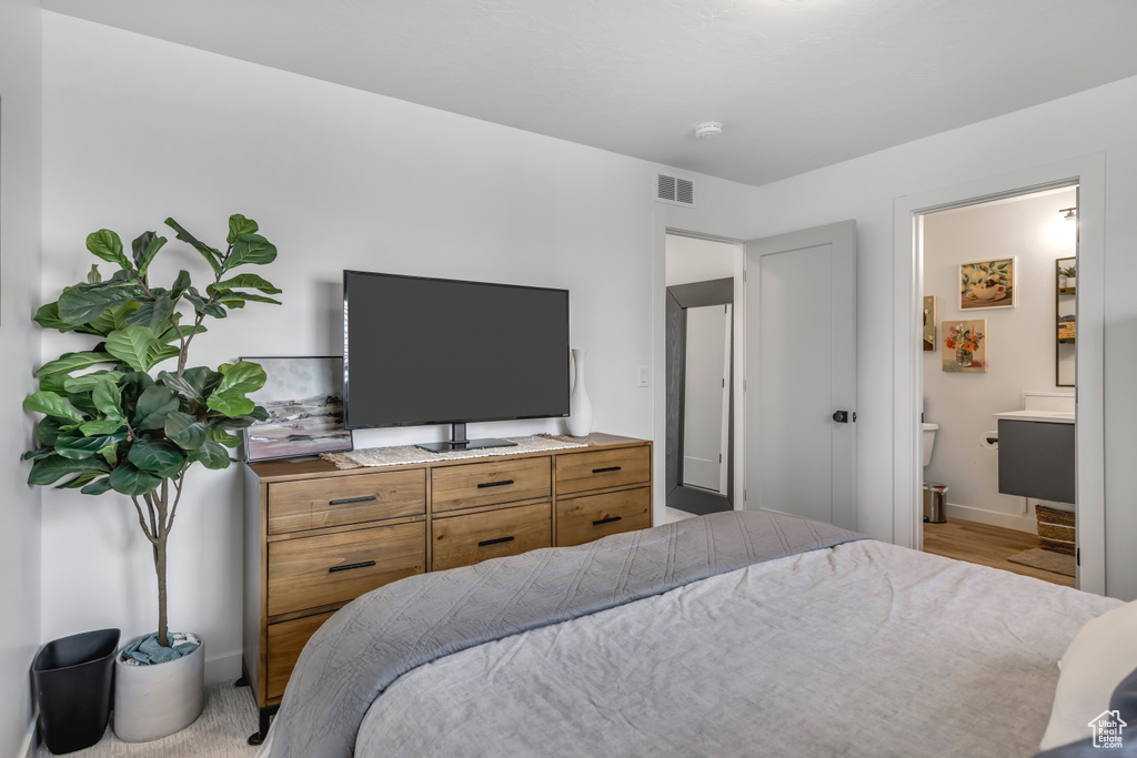 Bedroom with ensuite bath and baseboards