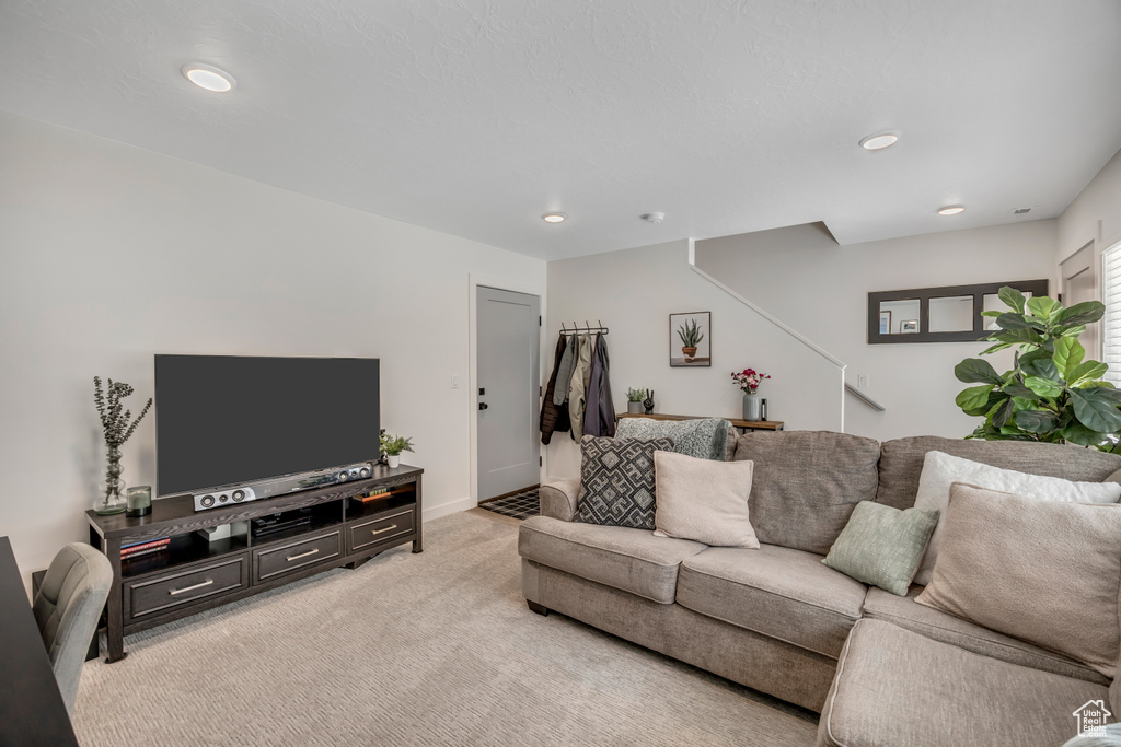 Living room with light carpet and recessed lighting