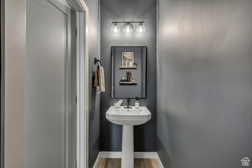 Bathroom with baseboards and wood finished floors