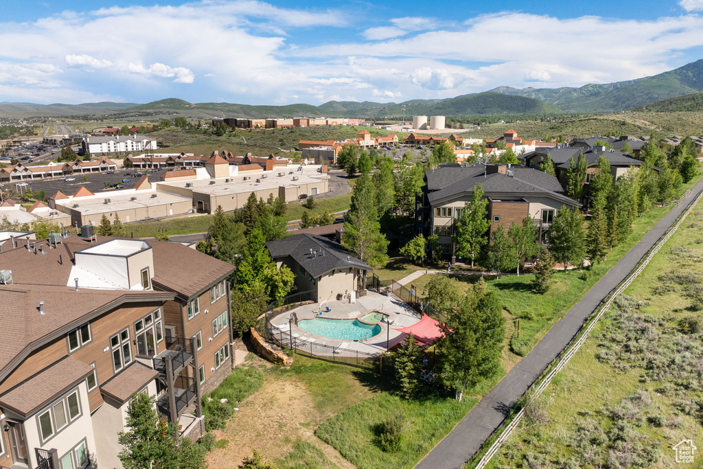 Aerial view of residential area featuring a pool and mountains