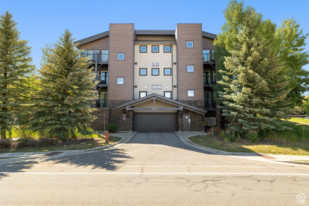 View of property featuring concrete driveway