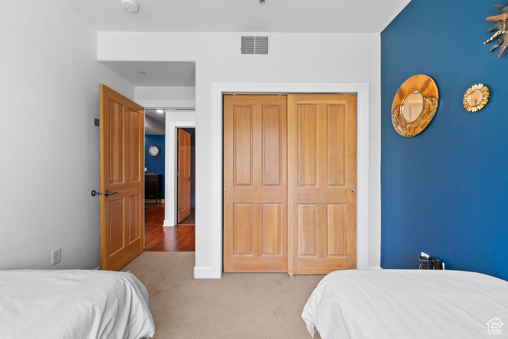 Carpeted bedroom featuring a closet