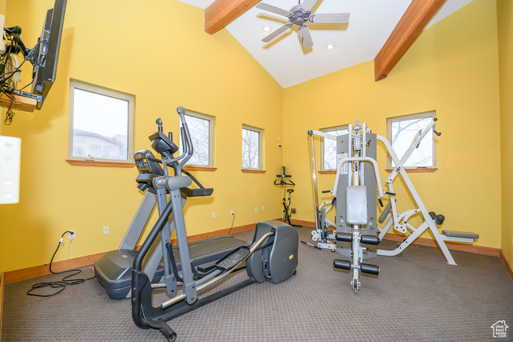 Workout area featuring high vaulted ceiling, baseboards, and ceiling fan